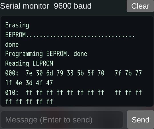 The serial monitor at 9600 baud: Erasing EEPROM, done; Programming EEPROM, done; Reading EEPROM, then the bytes 000: 7e 30 6d 79 33 5b 5f 70 7f 7b 77 1f 4e 3d 4f 47 and 010: ff ff ff; a line to send a message.